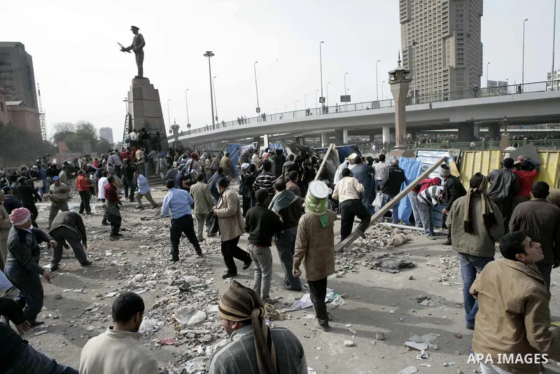 Egyptian protesters are seen in and around Tahrir square, as supporters and opponents of President Hosni Mubarak clash in some parts of the square, Cairo, capital of Egypt, Feb. 3, 2011. Egyptian army appeared to be tryi...