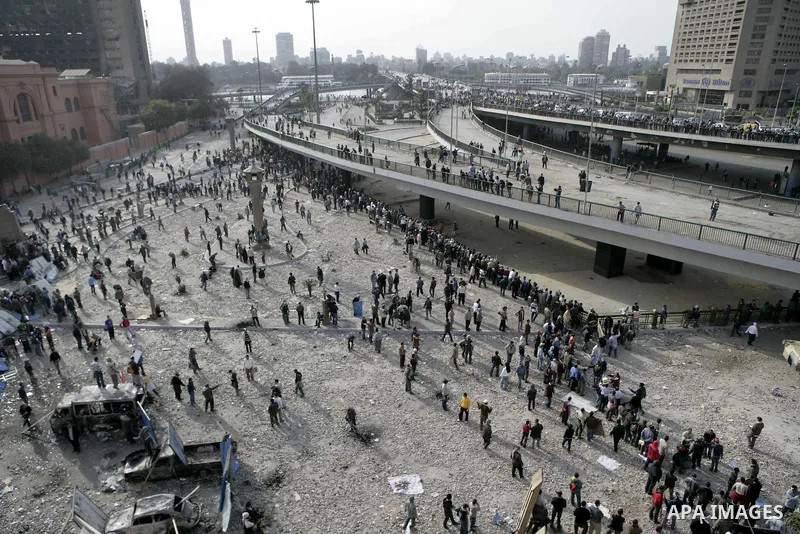 Egyptian protesters are seen in and around Tahrir square, as supporters and opponents of President Hosni Mubarak clash in some parts of the square, Cairo, capital of Egypt, Feb. 3, 2011. Egyptian army appeared to be tryi...