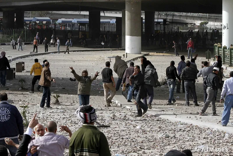 Egyptian protesters are seen in and around Tahrir square, as supporters and opponents of President Hosni Mubarak clash in some parts of the square, Cairo, capital of Egypt, Feb. 3, 2011. Egyptian army appeared to be tryi...