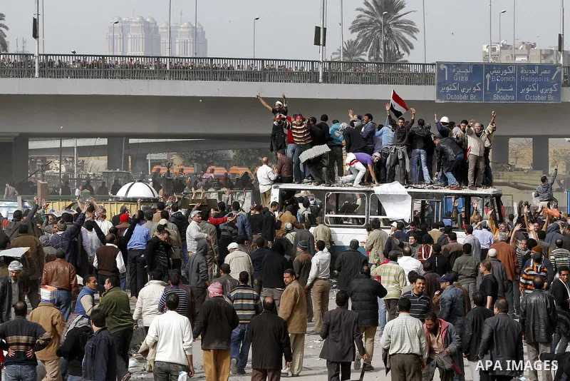 Egyptian protesters are seen in and around Tahrir square, as supporters and opponents of President Hosni Mubarak clash in some parts of the square, Cairo, capital of Egypt, Feb. 3, 2011. Egyptian army appeared to be tryi...