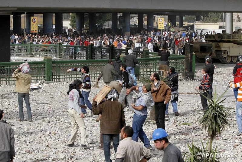 Egyptian protesters are seen in and around Tahrir square, as supporters and opponents of President Hosni Mubarak clash in some parts of the square, Cairo, capital of Egypt, Feb. 3, 2011. Egyptian army appeared to be tryi...