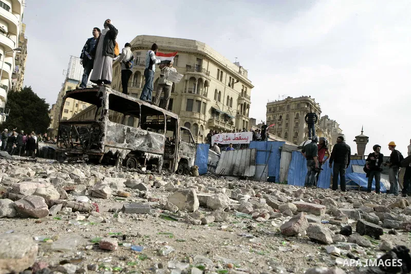 Egyptian protesters are seen in and around Tahrir square, as supporters and opponents of President Hosni Mubarak clash in some parts of the square, Cairo, capital of Egypt, Feb. 3, 2011. Egyptian army appeared to be tryi...