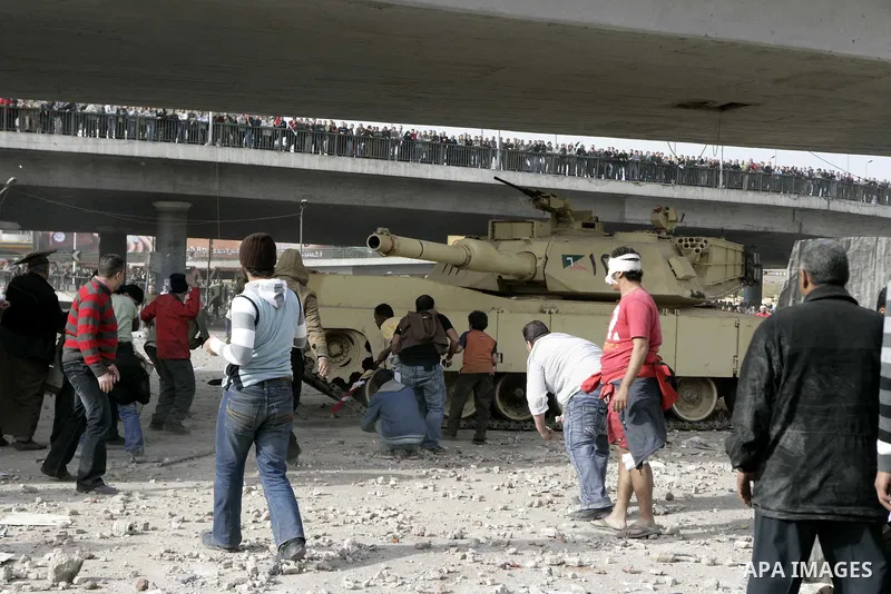 Egyptian protesters are seen in and around Tahrir square, as supporters and opponents of President Hosni Mubarak clash in some parts of the square, Cairo, capital of Egypt, Feb. 3, 2011. Egyptian army appeared to be tryi...