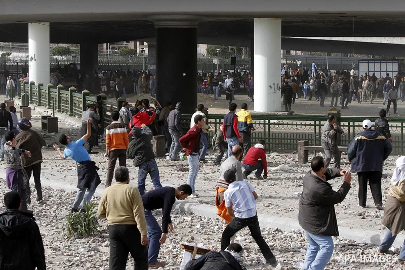 Egyptian protesters are seen in and around Tahrir square, as supporters and opponents of President Hosni Mubarak clash in some parts of the square, Cairo, capital of Egypt, Feb. 3, 2011. Egyptian army appeared to be tryi...