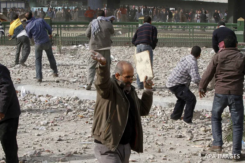 Egyptian protesters are seen in and around Tahrir square, as supporters and opponents of President Hosni Mubarak clash in some parts of the square, Cairo, capital of Egypt, Feb. 3, 2011. Egyptian army appeared to be tryi...