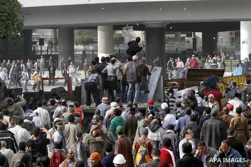 Egyptian protesters are seen in and around Tahrir square, as supporters and opponents of President Hosni Mubarak clash in some parts of the square, Cairo, capital of Egypt, Feb. 3, 2011. Egyptian army appeared to be tryi...