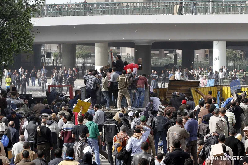 Egyptian protesters are seen in and around Tahrir square, as supporters and opponents of President Hosni Mubarak clash in some parts of the square, Cairo, capital of Egypt, Feb. 3, 2011. Egyptian army appeared to be tryi...