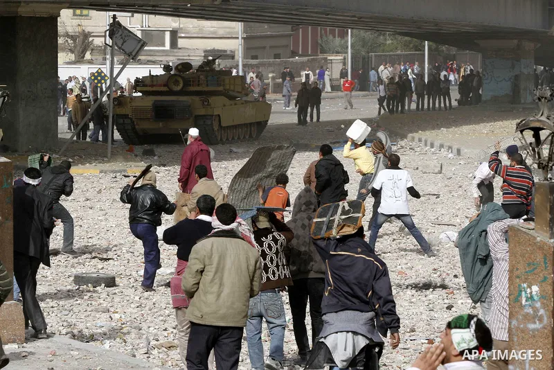 Egyptian protesters are seen in and around Tahrir square, as supporters and opponents of President Hosni Mubarak clash in some parts of the square, Cairo, capital of Egypt, Feb. 3, 2011. Egyptian army appeared to be tryi...