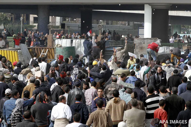 Egyptian protesters are seen in and around Tahrir square, as supporters and opponents of President Hosni Mubarak clash in some parts of the square, Cairo, capital of Egypt, Feb. 3, 2011. Egyptian army appeared to be tryi...