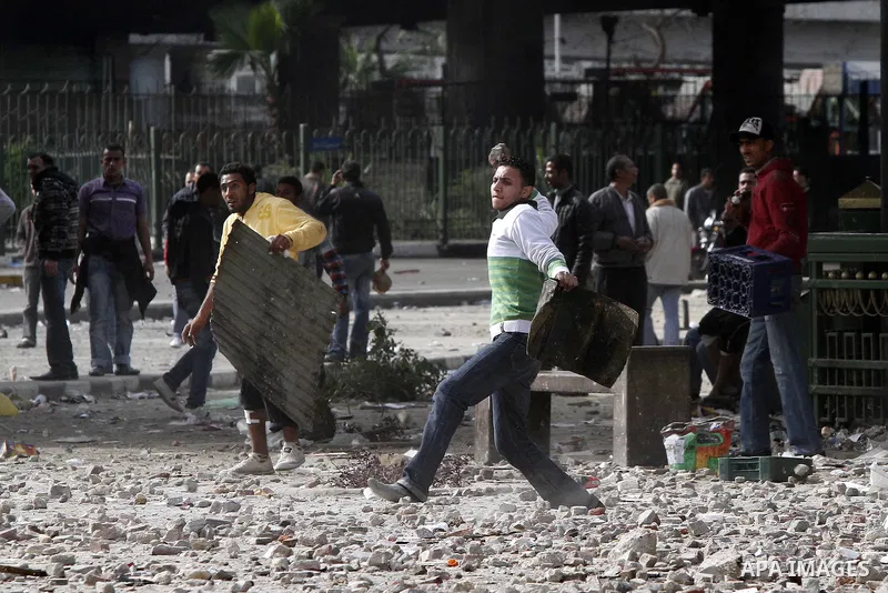 Egyptian protesters are seen in and around Tahrir square, as supporters and opponents of President Hosni Mubarak clash in some parts of the square, Cairo, capital of Egypt, Feb. 3, 2011. Egyptian army appeared to be tryi...