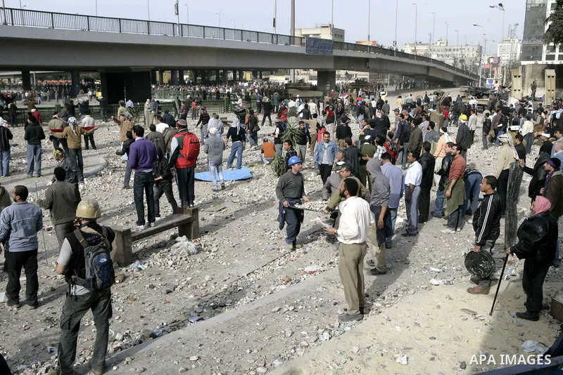 Egyptian protesters are seen in and around Tahrir square, as supporters and opponents of President Hosni Mubarak clash in some parts of the square, Cairo, capital of Egypt, Feb. 3, 2011. Egyptian army appeared to be tryi...