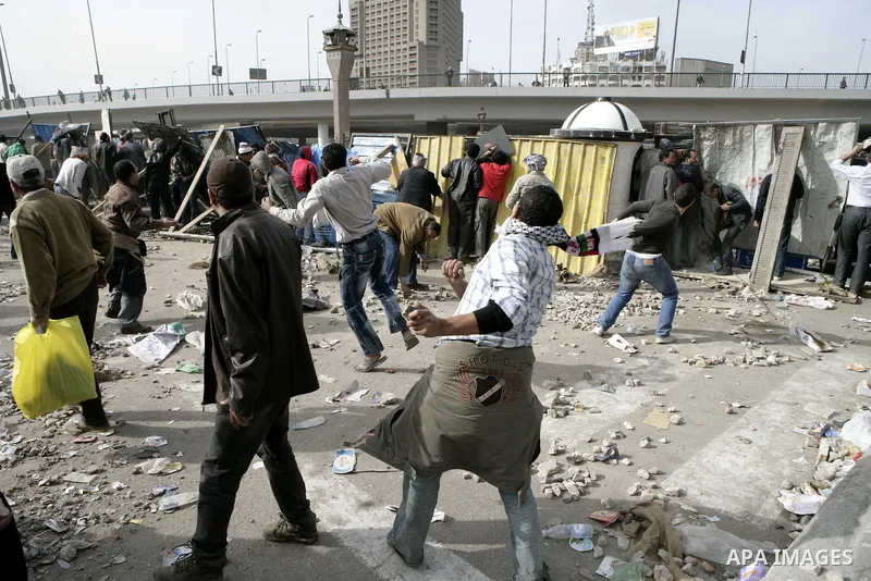 Egyptian protesters are seen in and around Tahrir square, as supporters and opponents of President Hosni Mubarak clash in some parts of the square, Cairo, capital of Egypt, Feb. 3, 2011. Egyptian army appeared to be tryi...