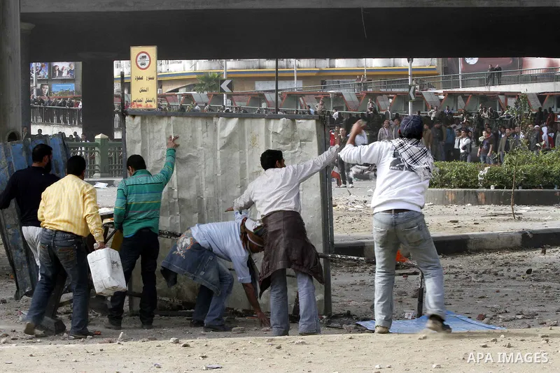 Egyptian protesters are seen in and around Tahrir square, as supporters and opponents of President Hosni Mubarak clash in some parts of the square, Cairo, capital of Egypt, Feb. 3, 2011. Egyptian army appeared to be tryi...