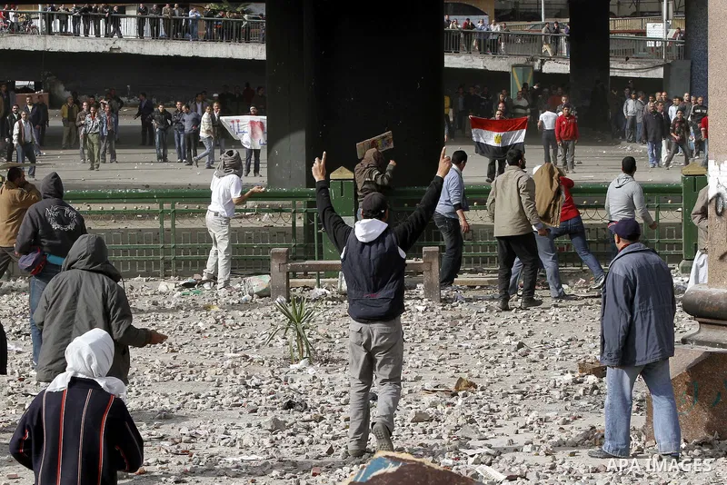 Egyptian protesters are seen in and around Tahrir square, as supporters and opponents of President Hosni Mubarak clash in some parts of the square, Cairo, capital of Egypt, Feb. 3, 2011. Egyptian army appeared to be tryi...