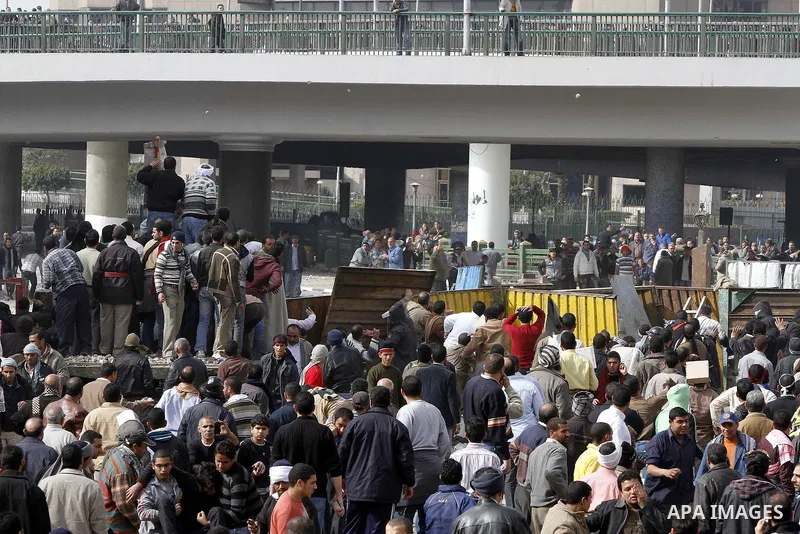Egyptian protesters are seen in and around Tahrir square, as supporters and opponents of President Hosni Mubarak clash in some parts of the square, Cairo, capital of Egypt, Feb. 3, 2011. Egyptian army appeared to be tryi...