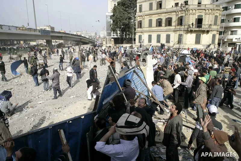 Egyptian protesters are seen in and around Tahrir square, as supporters and opponents of President Hosni Mubarak clash in some parts of the square, Cairo, capital of Egypt, Feb. 3, 2011. Egyptian army appeared to be tryi...