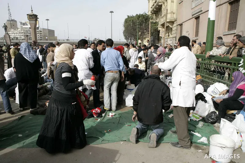 Egyptian protesters are seen in and around Tahrir square, as supporters and opponents of President Hosni Mubarak clash in some parts of the square, Cairo, capital of Egypt, Feb. 3, 2011. Egyptian army appeared to be tryi...