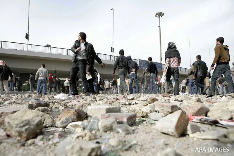 Egyptian protesters are seen in and around Tahrir square, as supporters and opponents of President Hosni Mubarak clash in some parts of the square, Cairo, capital of Egypt, Feb. 3, 2011. Egyptian army appeared to be tryi...