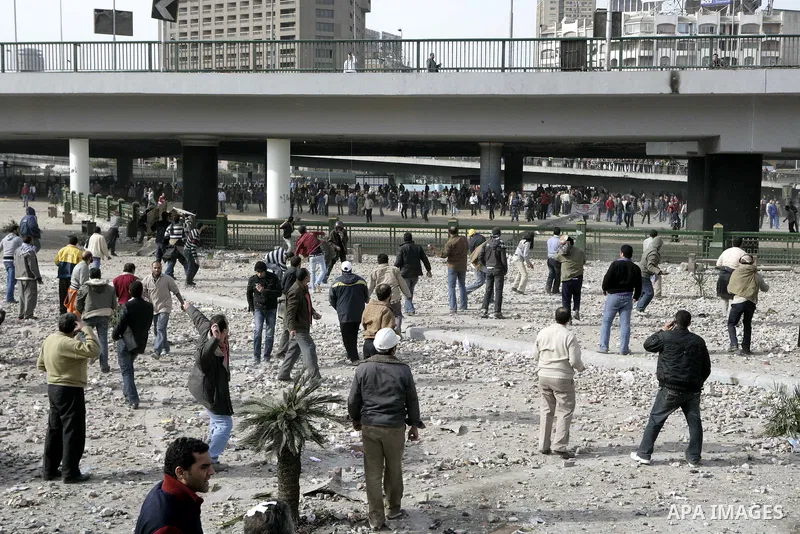 Egyptian protesters are seen in and around Tahrir square, as supporters and opponents of President Hosni Mubarak clash in some parts of the square, Cairo, capital of Egypt, Feb. 3, 2011. Egyptian army appeared to be tryi...