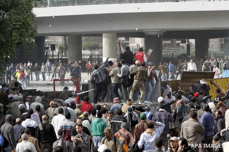 Egyptian protesters are seen in and around Tahrir square, as supporters and opponents of President Hosni Mubarak clash in some parts of the square, Cairo, capital of Egypt, Feb. 3, 2011. Egyptian army appeared to be tryi...