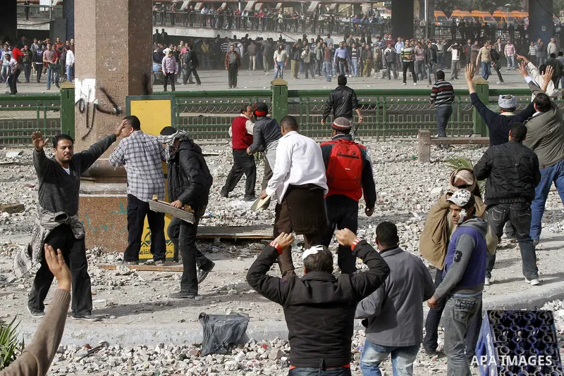 Egyptian protesters are seen in and around Tahrir square, as supporters and opponents of President Hosni Mubarak clash in some parts of the square, Cairo, capital of Egypt, Feb. 3, 2011. Egyptian army appeared to be tryi...