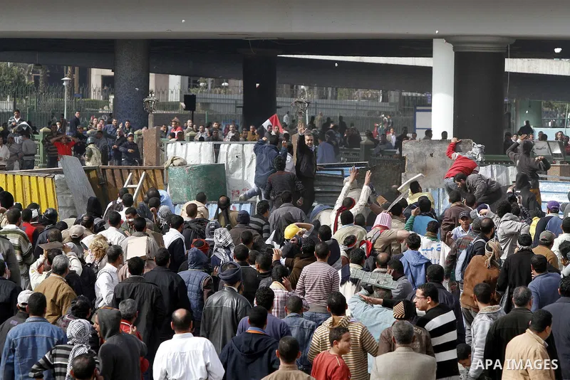 Egyptian protesters are seen in and around Tahrir square, as supporters and opponents of President Hosni Mubarak clash in some parts of the square, Cairo, capital of Egypt, Feb. 3, 2011. Egyptian army appeared to be tryi...