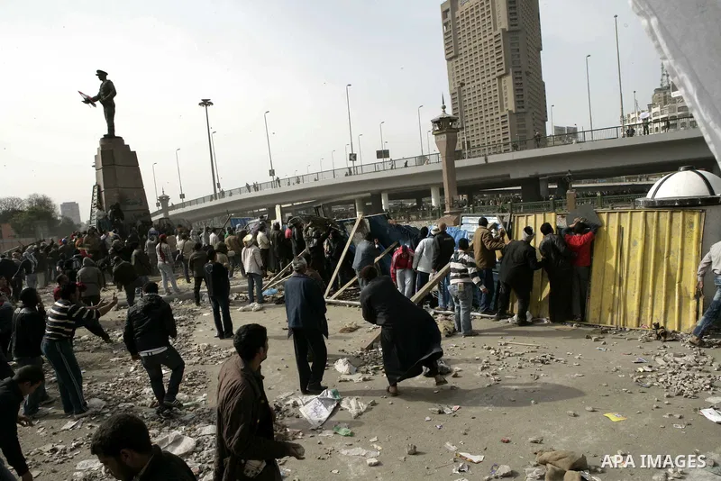 Egyptian protesters are seen in and around Tahrir square, as supporters and opponents of President Hosni Mubarak clash in some parts of the square, Cairo, capital of Egypt, Feb. 3, 2011. Egyptian army appeared to be tryi...