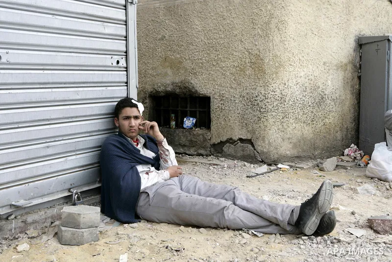 An injured protestor sits at Tahrir Square, Cairo, Egypt, Feb. 4, 2011. Egyptian minister of Health said Friday that about five thousand people have been injured since Jan. 25, and eight have been killed in clashes betwe...