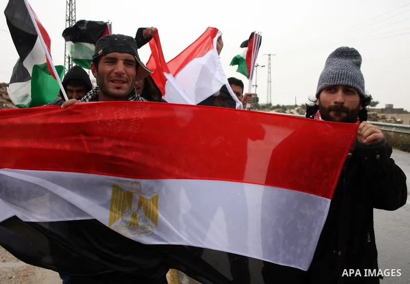 Palestinian protestors shout slogans and hold Egyptian flag and Palestinian flag during a demonstration in support of the protests in Egypt, after the Friday prayer in the West Bank village of Maasarah,near the biblical...
