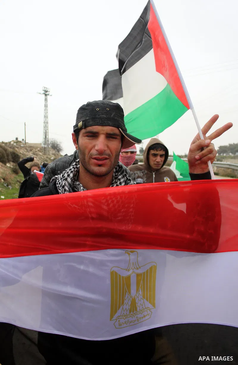 Palestinian protestors shout slogans and hold Egyptian flag and Palestinian flag during a demonstration in support of the protests in Egypt, after the Friday prayer in the West Bank village of Maasarah,near the biblical...