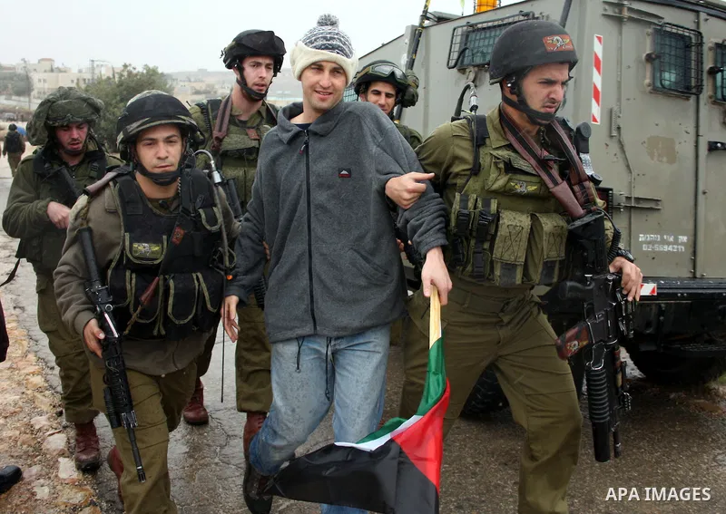Israeli soldiers arrest a demonstrator during a protest against Israel's controversial separation barrier in the West Bank village of Wad Rahal,near the biblical town of Bethlehem, on February 04, 2011. Israel says the n...