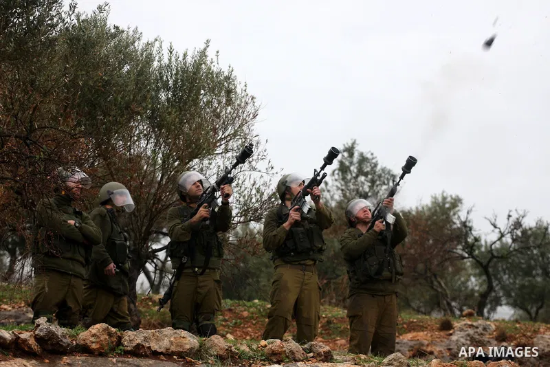 Israeli sildiers fire tear gas canisters towards Palestinian protesters during a protest in the village of Bilin on Feb. 4, 2011. Photo by Issam Rimawi