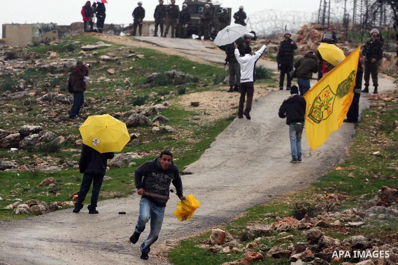 Israeli sildiers fire tear gas canisters towards Palestinian protesters during a protest in the village of Bilin on Feb. 4, 2011. Photo by Issam Rimawi