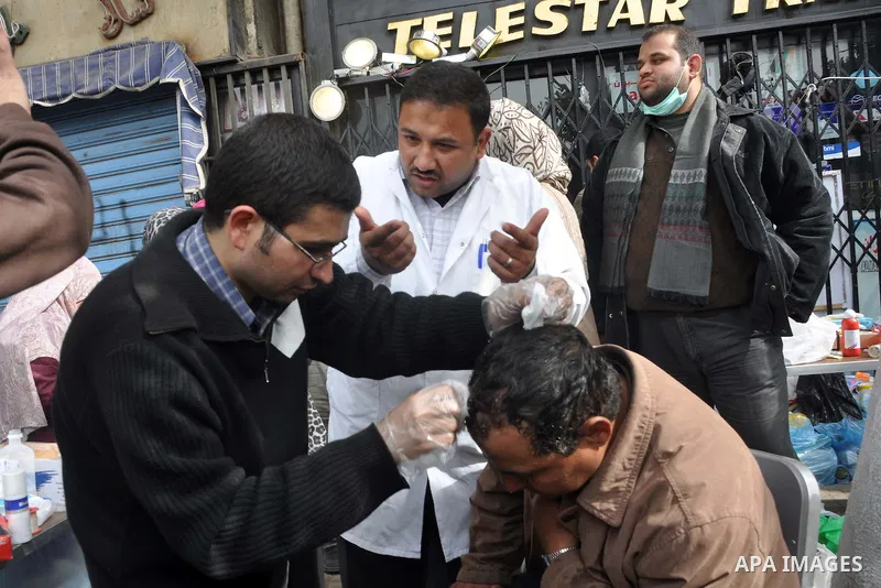 An injured Egyptian protestor receives treatment at Tahrir Square, Cairo, Egypt, Feb. 4, 2011. Egyptian minister of Health said Friday that about five thousand people have been injured since Jan. 25, and eight have been...