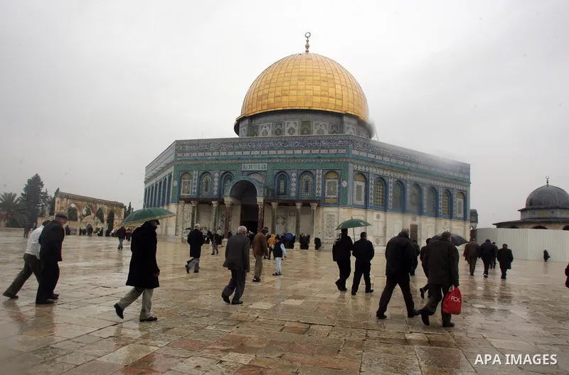 Palestinian Muslims walk in front of the Dome of the Rock after Fridays prayers in the old city of Jerusalem on Feb. 4,2011. Photo by Mahfouz Abu Turk