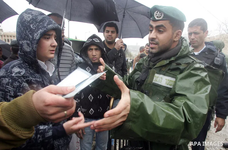 Israeli soldiers check Palestinian worrshippers aim to attend Friday prayers outside the Al Aqsa Mosque compound, also known to Jews as the Temple Mount, in Jerusalem's old city in the old city of Jerusalem on Feb. 4,201...