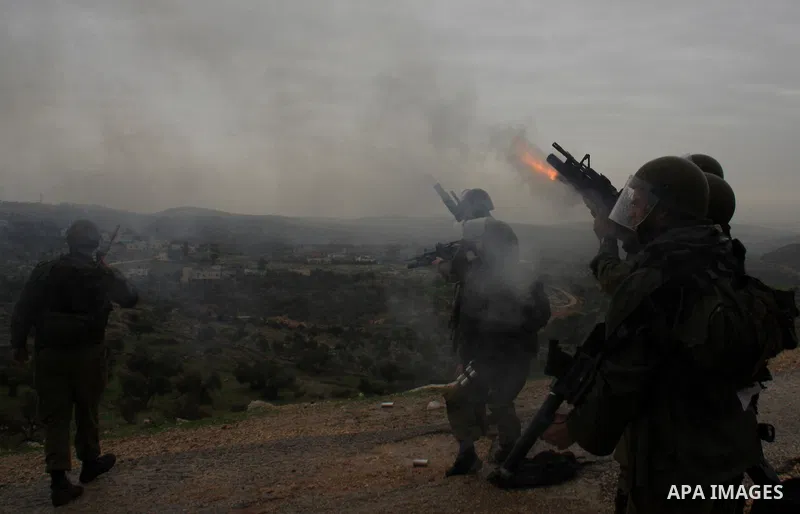 Israeli sildiers fire tear gas canisters towards Palestinian protesters during a protest in the village of Bilin near Ramallah on Feb. 4, 2011. Photo by Wagdi Eshtayah