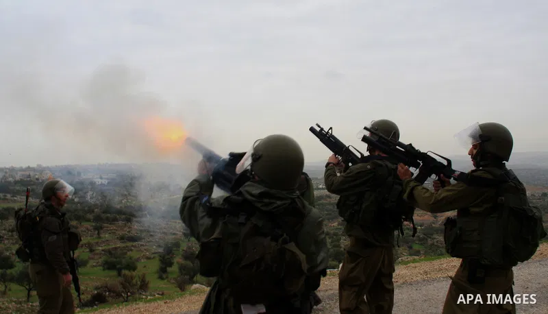 Israeli sildiers fire tear gas canisters towards Palestinian protesters during a protest in the village of Bilin near Ramallah on Feb. 4, 2011. Photo by Wagdi Eshtayah