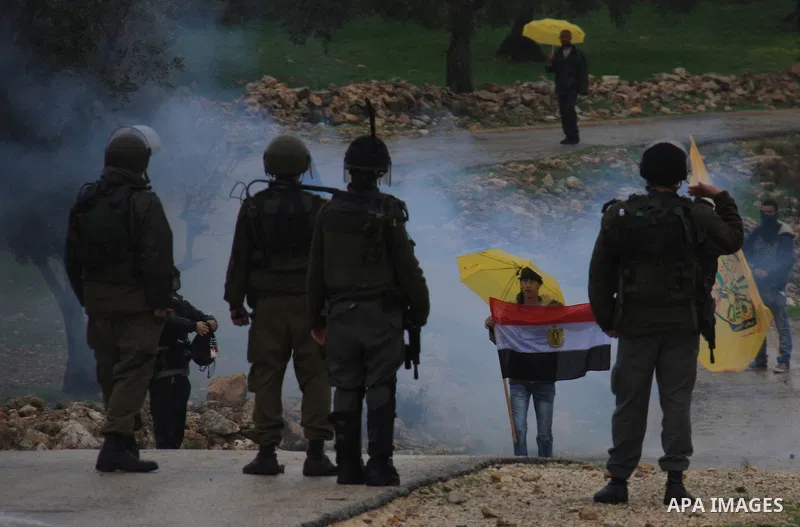 Israeli sildiers fire tear gas canisters towards Palestinian protesters during a protest in the village of Bilin near Ramallah on Feb. 4, 2011. Photo by Wagdi Eshtayah