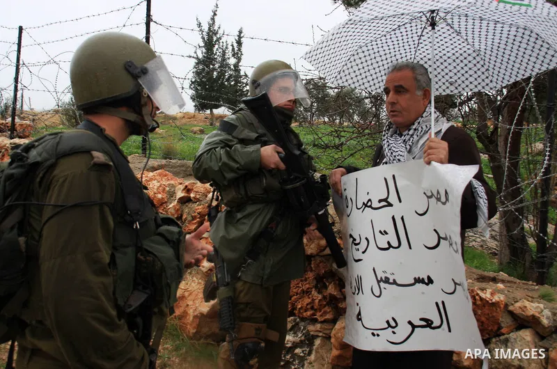 Israeli soldiers stand guards during a protest against Israel's separation barrier in the West Bank village of Bilin near Ramallah, Friday, Feb 4, 2011. Photo by Wagdi Eshtayah