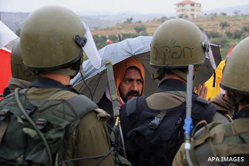 Israeli soldiers stand guards during a protest against Israel's separation barrier in the West Bank village of Bilin near Ramallah, Friday, Feb 4, 2011. Photo by Wagdi Eshtayah