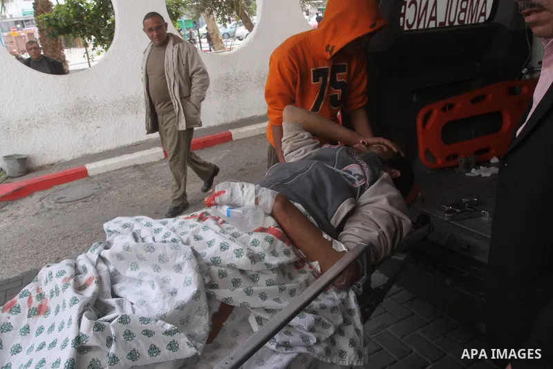 A wounded Palestinian is wheeled into Gaza City's Al-Shifa hospital in Gaza City, Feb. 5, 2011. A three Palestinian were wounded Saturday when Israeli troops opened fire on Palestinian workers who collect stones in easte...