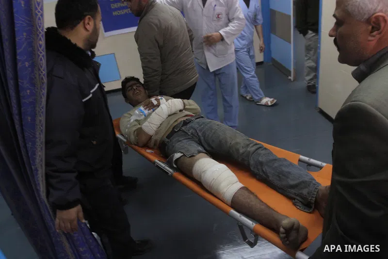 A wounded Palestinian is wheeled into Gaza City's Al-Shifa hospital in Gaza City, Feb. 5, 2011. A three Palestinian were wounded Saturday when Israeli troops opened fire on Palestinian workers who collect stones in easte...