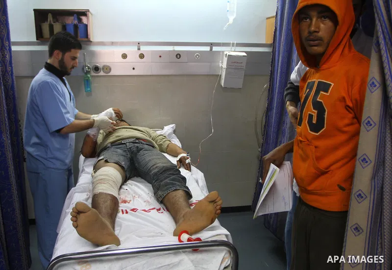 A Palestinian youth receives treatment at a hospital after he injured by Israeli fire near the fence in the east of Gaza city on Feb. 5,2011. Photo by Ashraf Amra