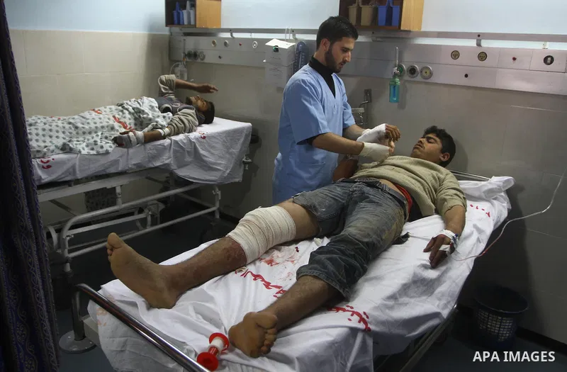 A Palestinian youth receives treatment at a hospital after he injured by Israeli fire near the fence in the east of Gaza city on Feb. 5,2011. Photo by Ashraf Amra