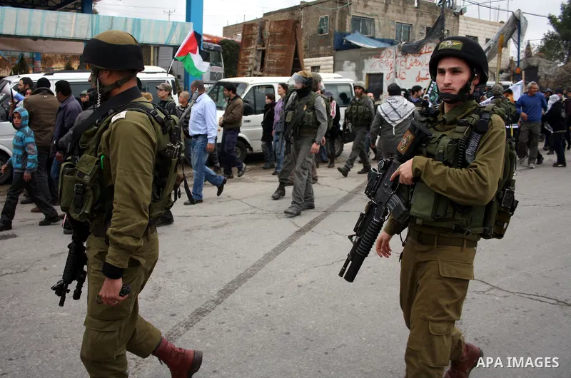 Israeli soldiers take position during during a demonstration against the Israeli controversial separation barrier in the West Bank village of Beit Omar, near Hebron, 05 February 2011. Israel says the network of steel and...