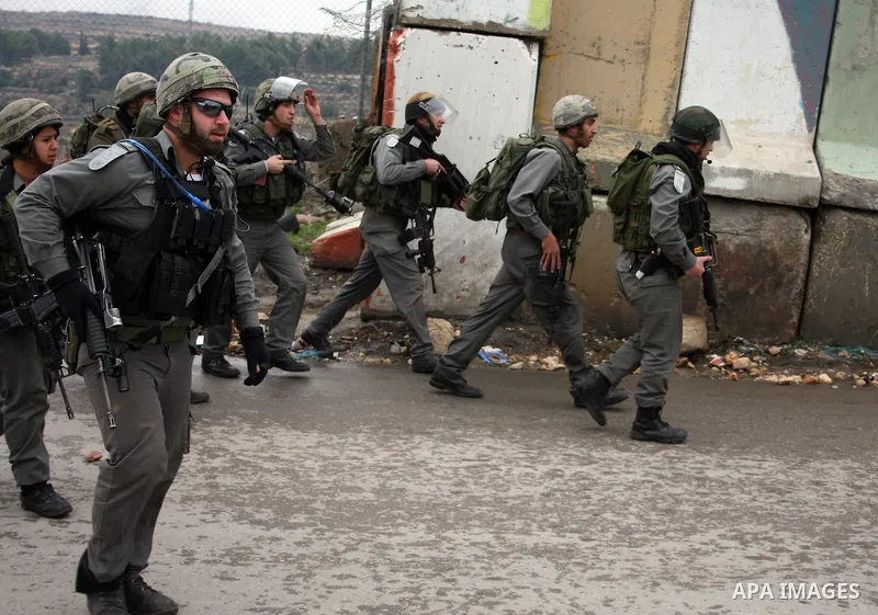 Israeli soldiers take position during during a demonstration against the Israeli controversial separation barrier in the West Bank village of Beit Omar, near Hebron, 05 February 2011. Israel says the network of steel and...