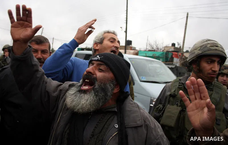 Demonstrators consisting of Palestinians, foreign protesters and leftwing Israeli peace activists take part in a demonstration against the Israeli controversial separation barrier in the West Bank village of Beit Omar, n...