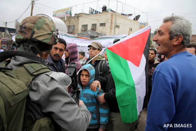 Demonstrators consisting of Palestinians, foreign protesters and leftwing Israeli peace activists take part in a demonstration against the Israeli controversial separation barrier in the West Bank village of Beit Omar, n...