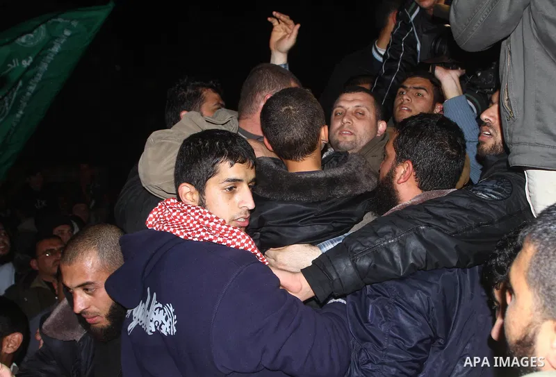 Ayman Nofal a prominent member of the Palestinian militant group Hamas' military wing Al-Qassam waves to his supporters upon his arrival back home in Gaza Strip's Nusairat refugee camp on February 5, 2011. Ayman Nofal es...